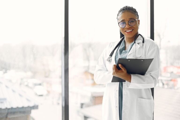 Professional female doctor smiling confidently holding a clipboard indoors.